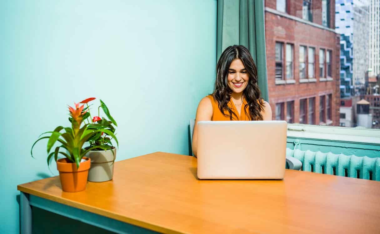 Girl using AI writer on laptop