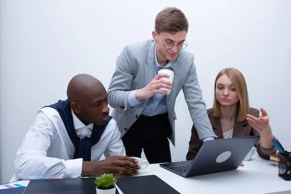 AI Marketing Analytics: Unlocking it's Potential 4 man and woman looking at the laptop
