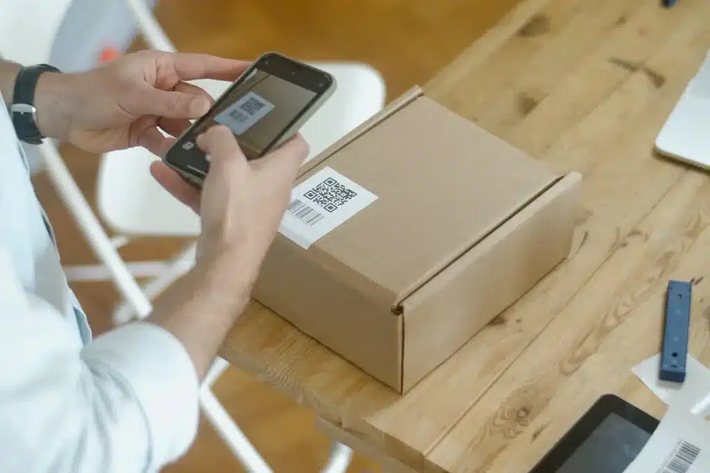 a person holding a phone and a box